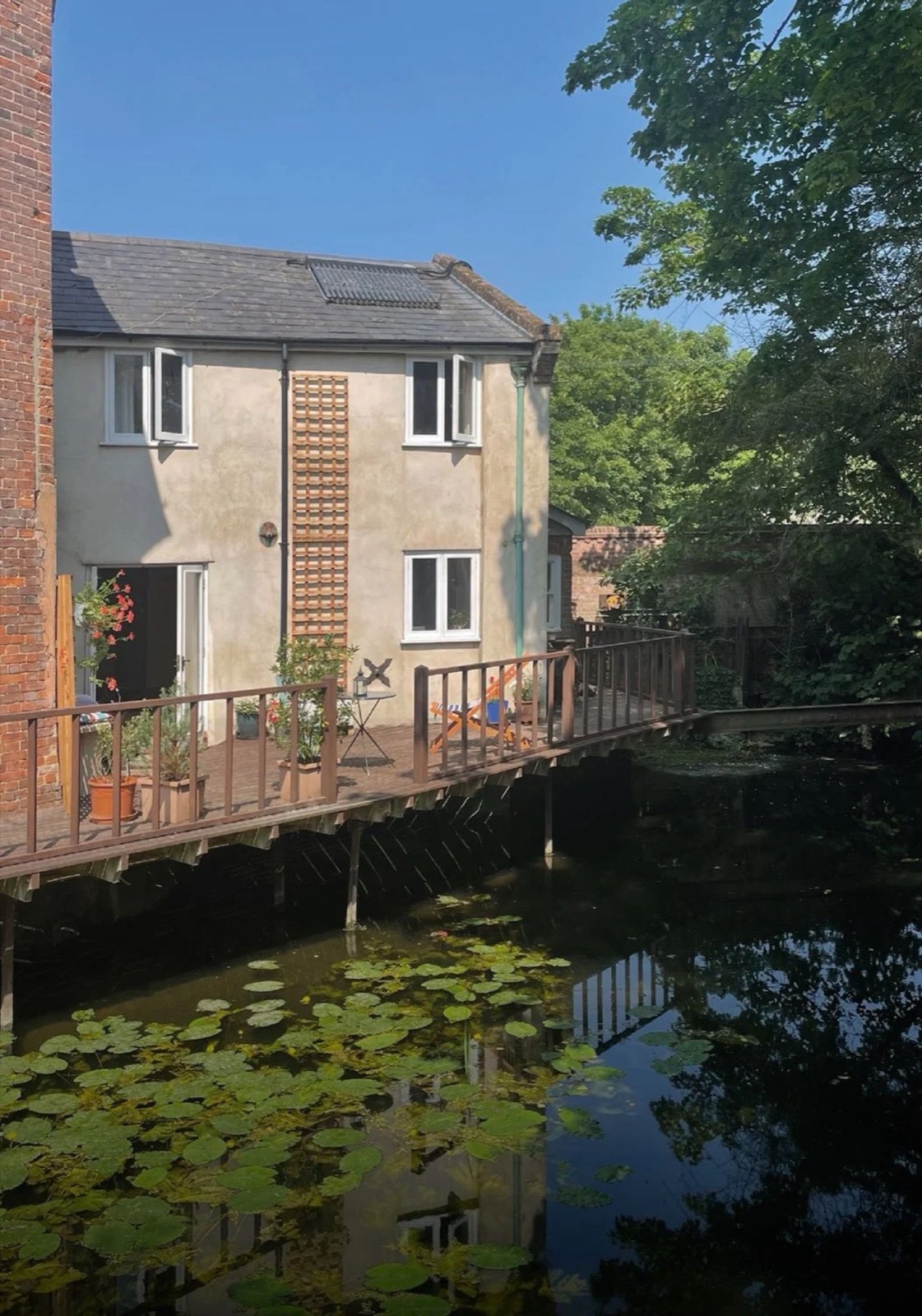 Wainford Mill Cottage on its deck over the water